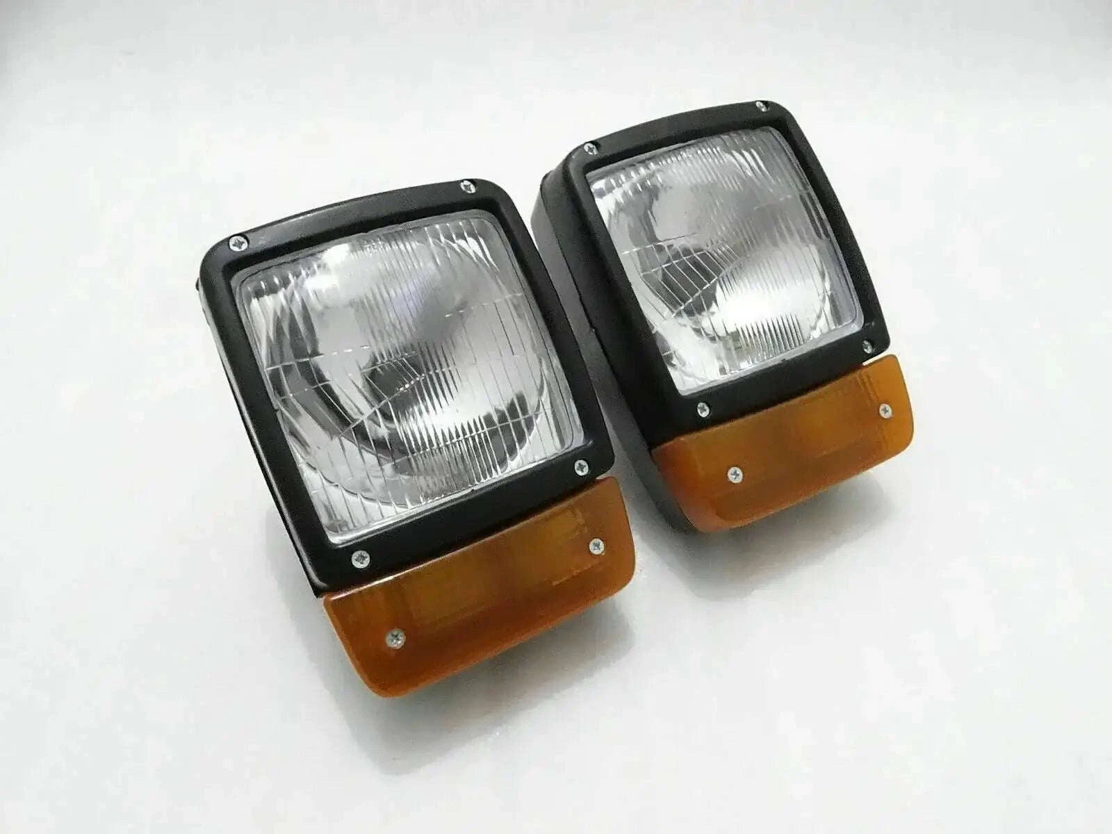 Pair of front headlights with amber indicator lenses, rectangular H4 lamps