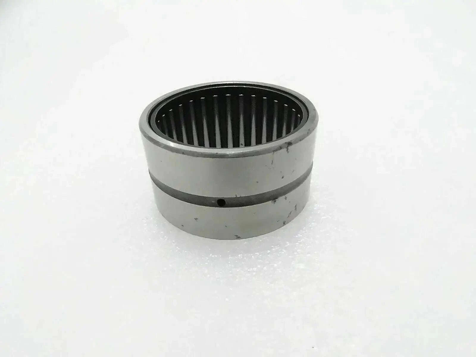 Needle bearing bushing with cylindrical metal housing and inner roller cage