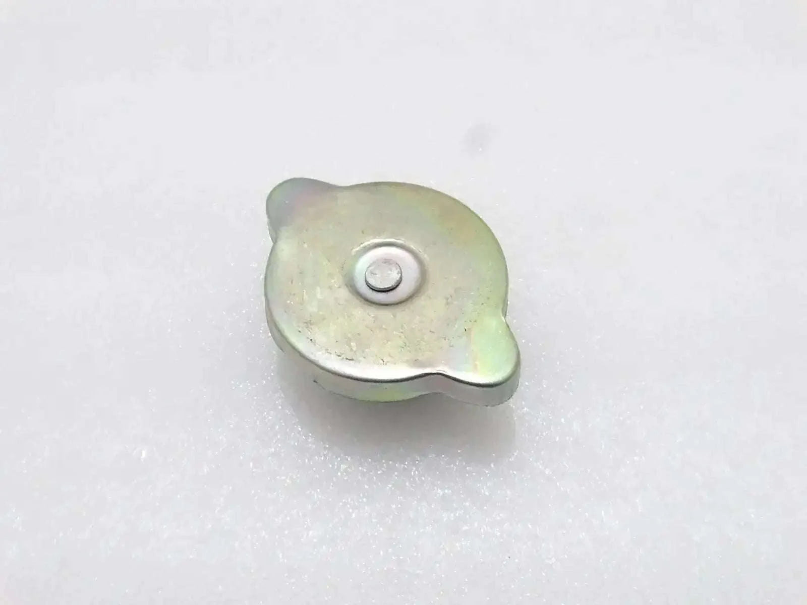 Radiator cap, light yellow-green metal with round center button