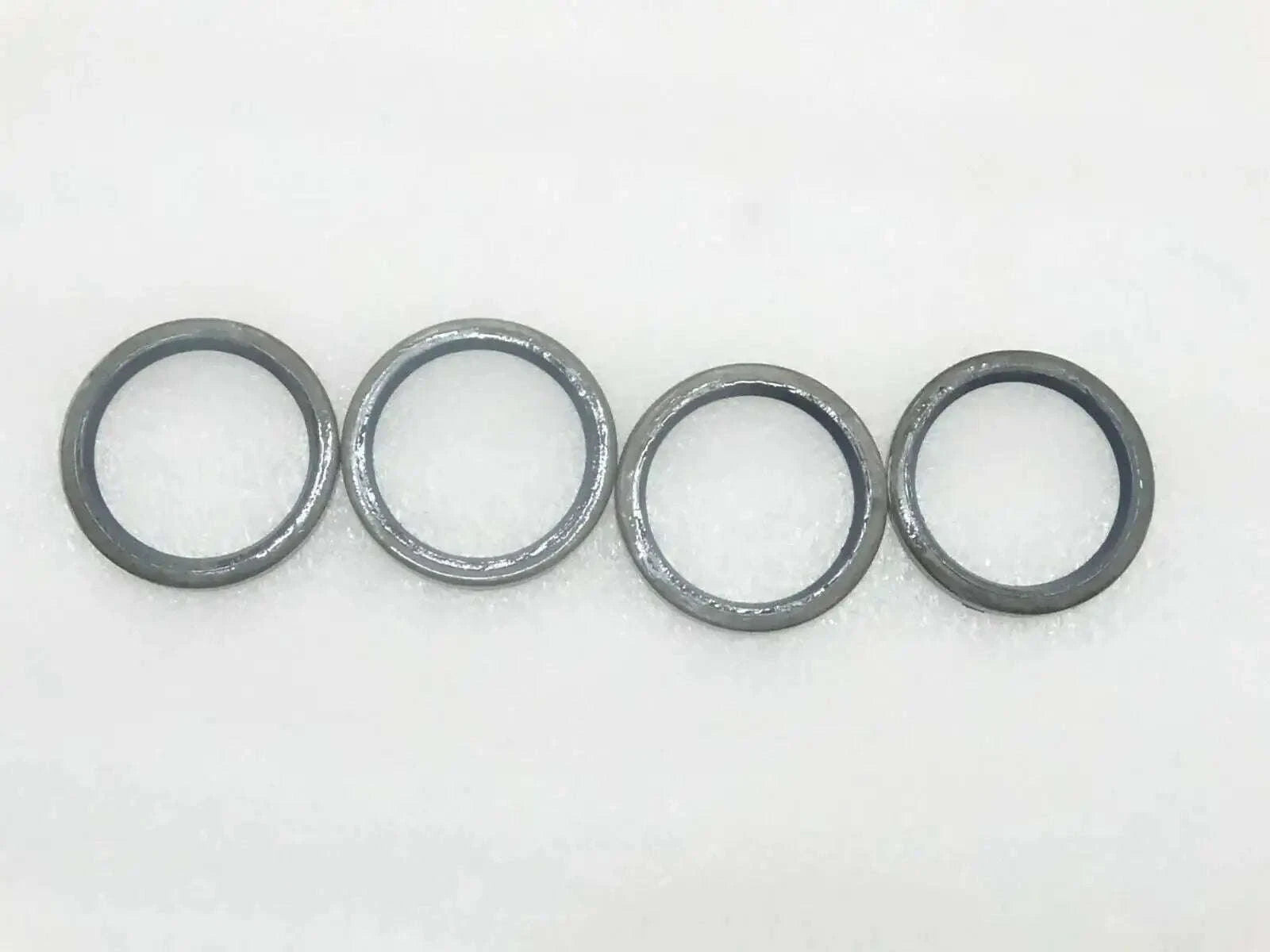 JCB seal pivot pin grease set, four durable metal rings for effective lubrication in machinery