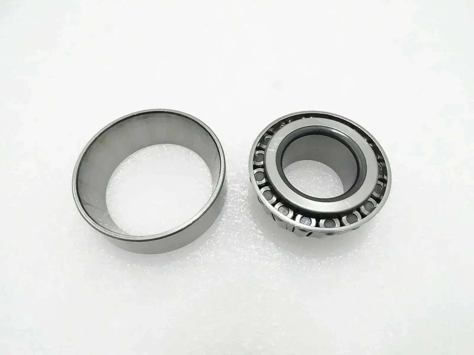 Thrust bearing with metal cage and roller assembly, shown with two rings