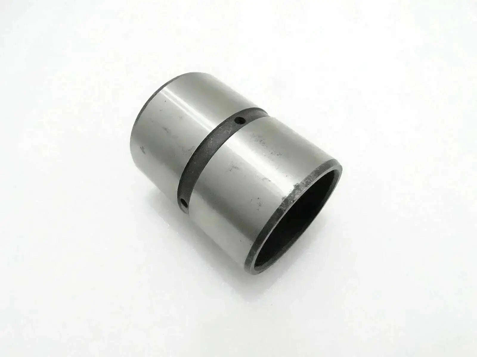 Cylindrical metal bushing with dark rubber ring