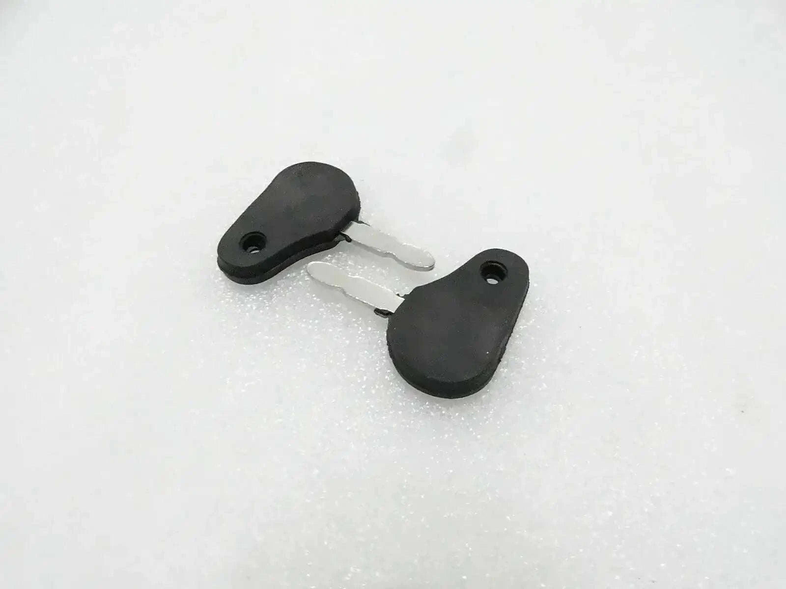 Tractor ignition starter key with black plastic head and metal blade