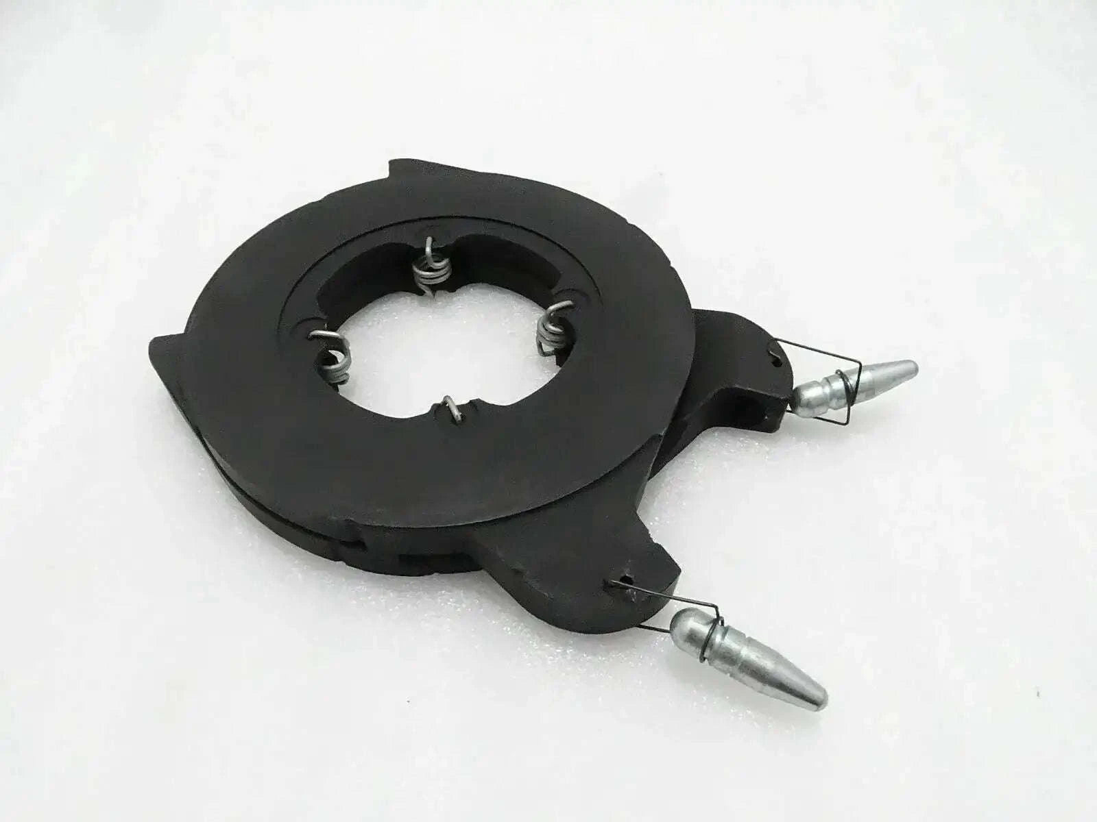 Brake actuating assembly with black circular housing and metal lever arms