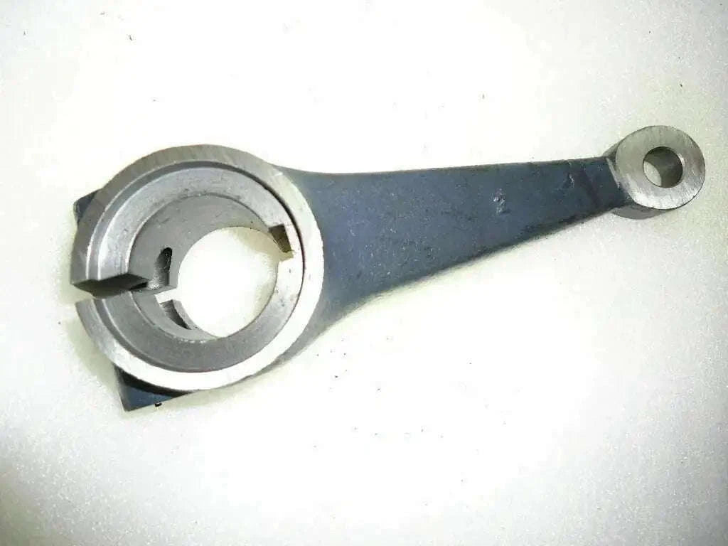Front axle spindle arm, dark metal bar with circular bearing opening and bolt hole