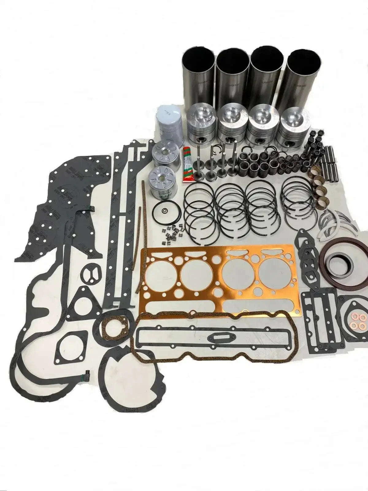 Engine rebuild kit parts with gaskets, seals, bolts, and cylinder liners