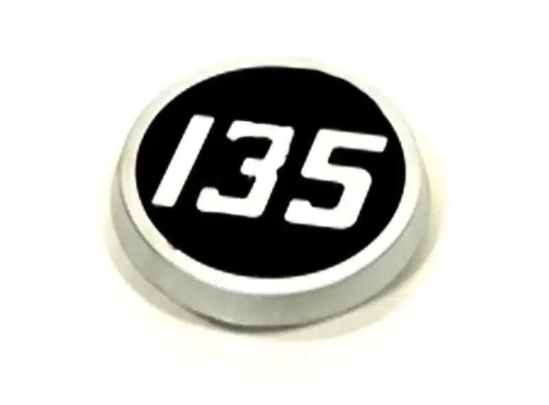 Tractor side bonnet emblem badge with “135” on black oval, silver rim