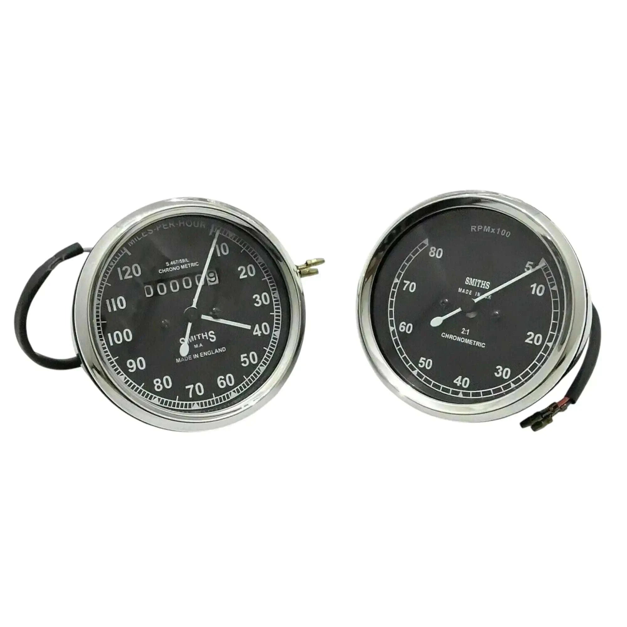 Speedometer gauge pair with chrome bezels, black faces, visible wiring on one unit