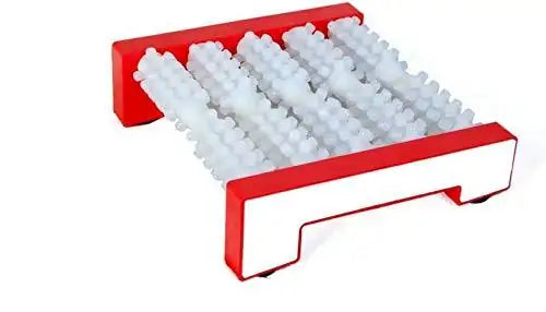 Red foot acupressure massager with raised white nubs on a flat platform