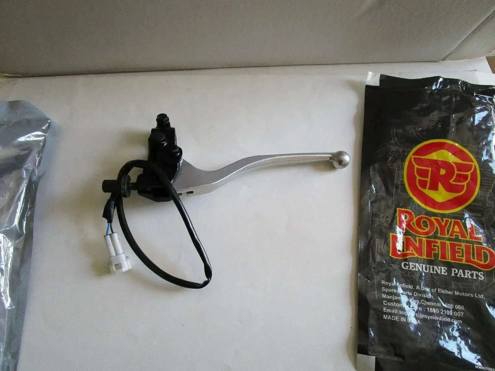 Clutch lever assembly with black handle, silver lever and attached cables