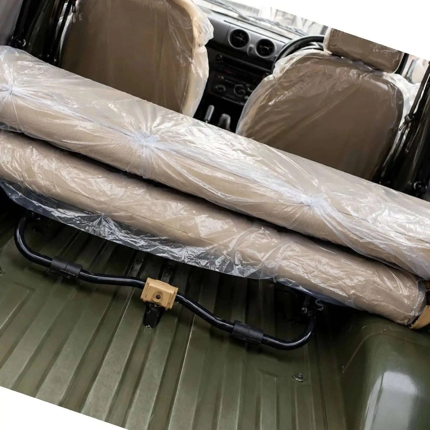 Foldable rear seat bench in beige fabric, designed for easy installation of infant car seat rear facing.
