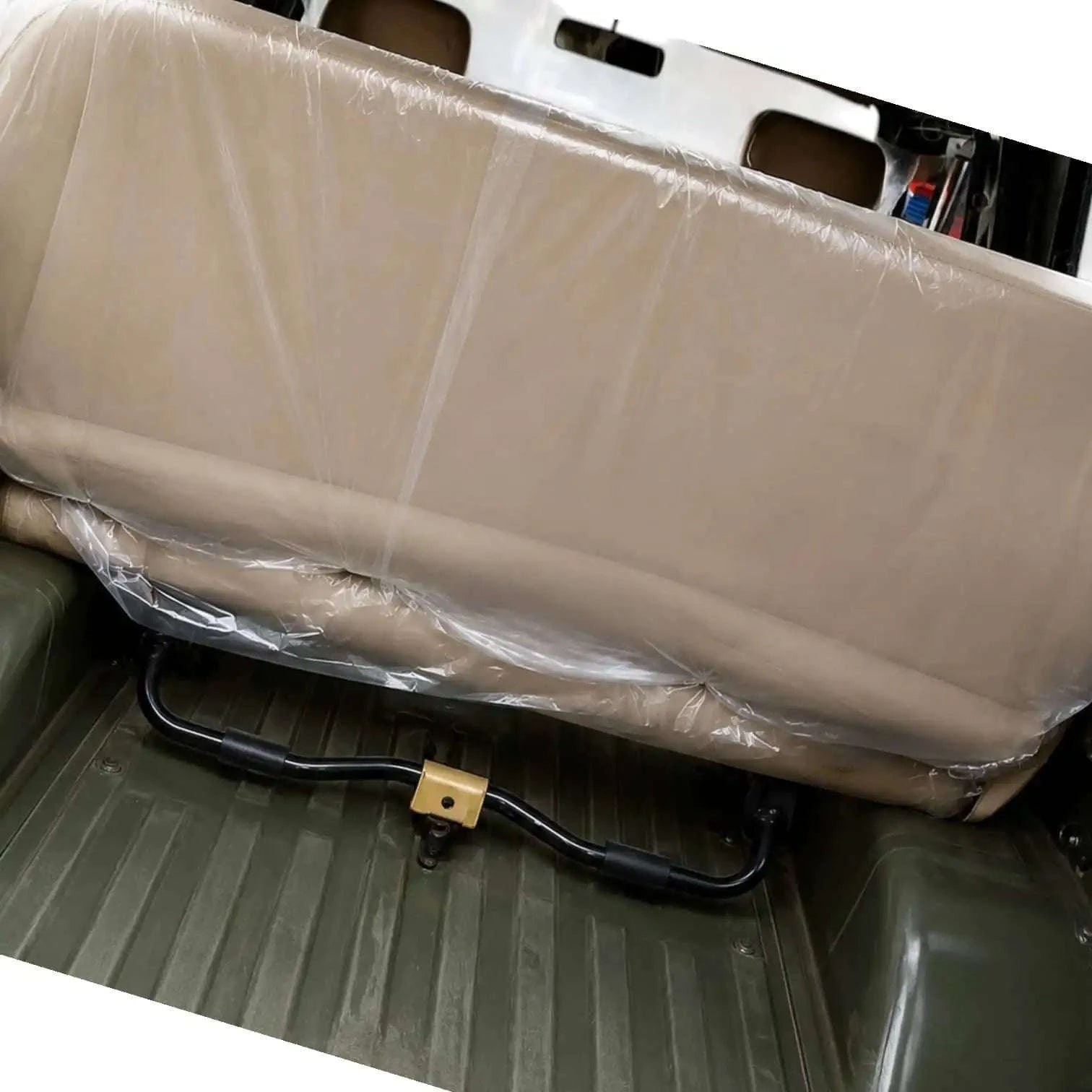 Foldable rear seat bench in beige, designed to accommodate an infant car seat rear facing