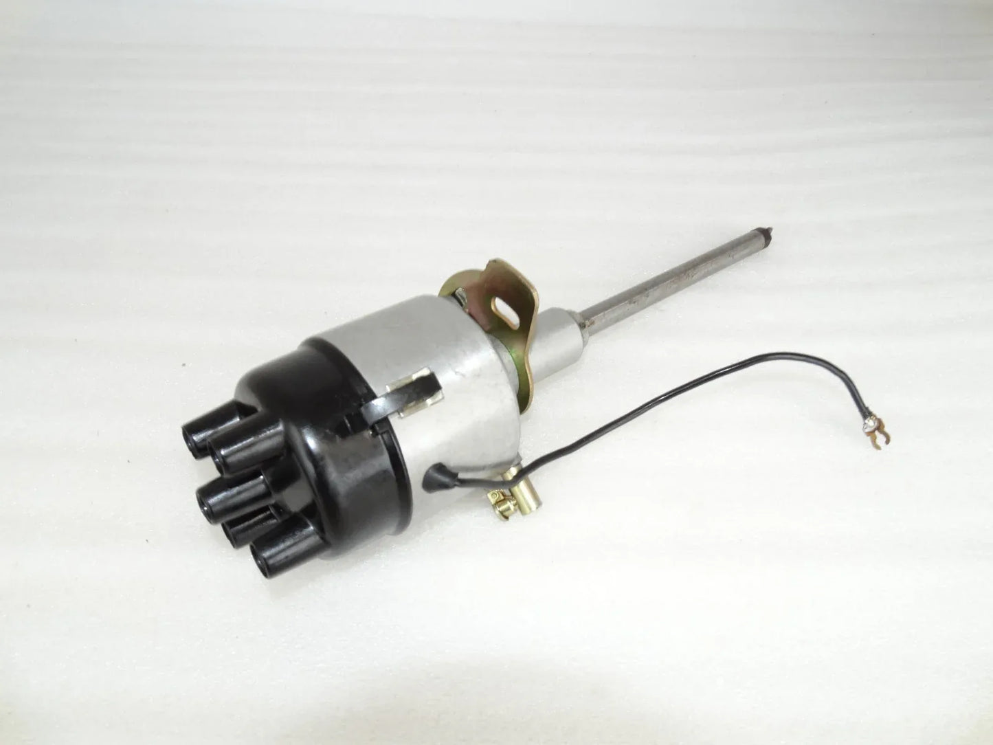 Complete distributor assembly with metal shaft, black housing, and wiring harness