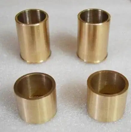 Set of four brass fork bushings designed for use with fork bushing removal tool in vehicle maintenance