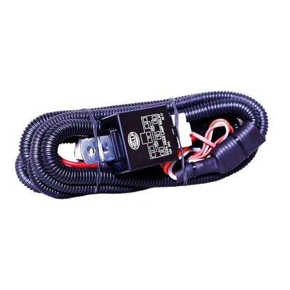 Headlight relay module on dark braided wiring harness with red and white wire leads