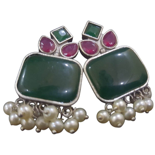 Handcrafted brass drop earrings featuring green stones and pearl accents for a stylish look