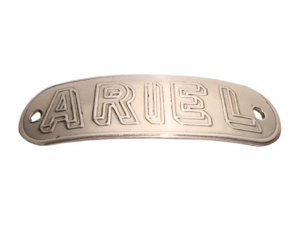 Metal tank badge with raised ARIEL lettering, oval shape, dark silver