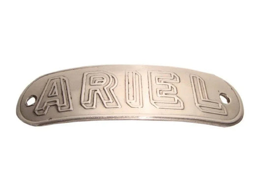 Metal tank badge with raised ARIEL lettering, oval shape, dark silver