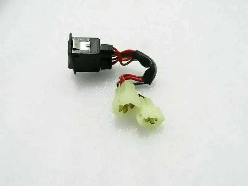 Hazard switch with black housing, red/black wires, and yellow plastic connector
