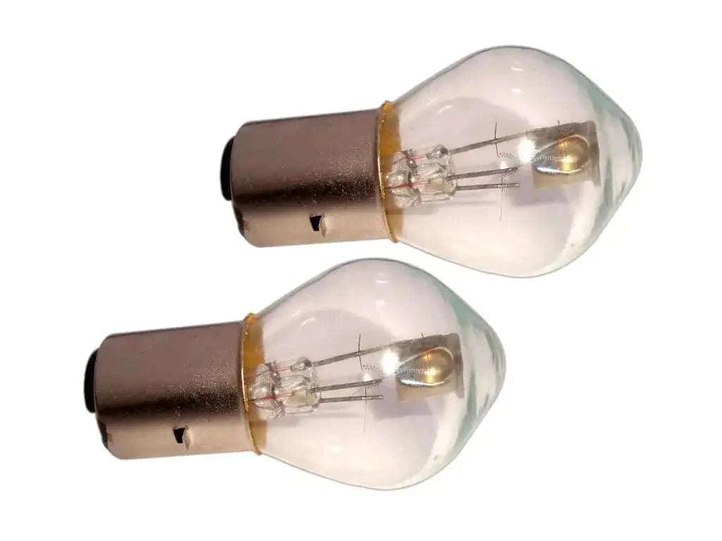 Headlight bulb set with shield, clear glass domes and brown base, visible filaments (12V)