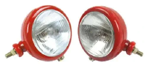 Red round tractor headlight pair with clear lenses and side mounting brackets
