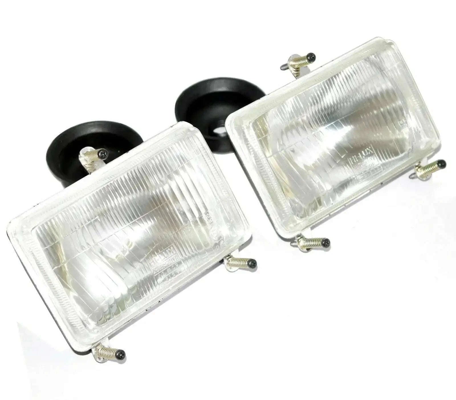 Rectangular tractor headlamp set with clear lens, mounting screws, and black brackets