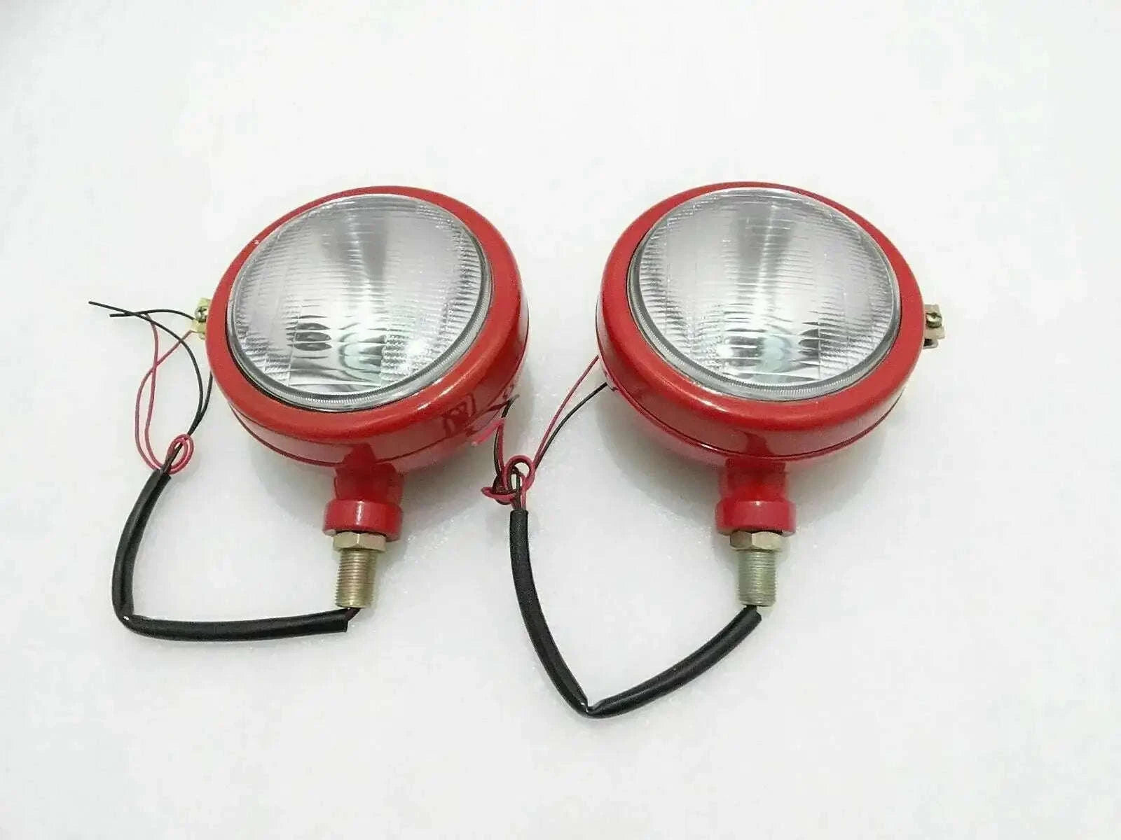 Pair of red tractor headlights with clear lenses and wiring, including parking bulb slot