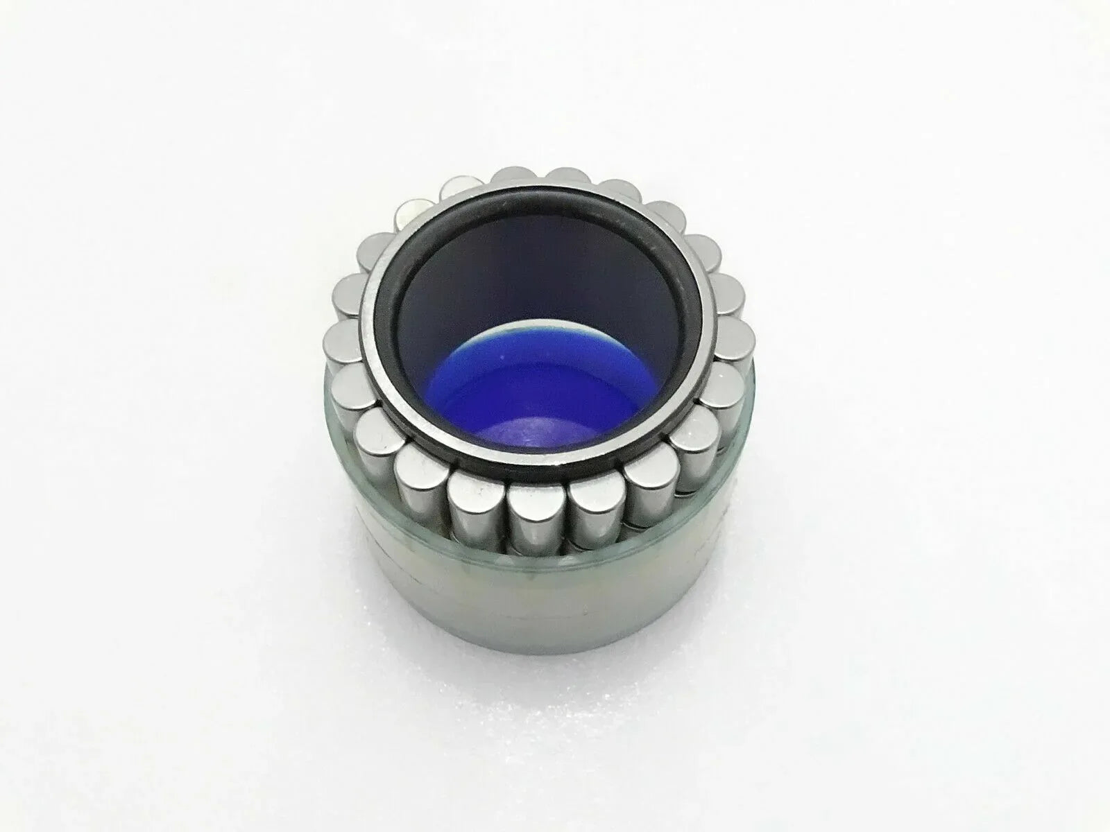Jcb hub roller bearing with exposed rollers and blue inner grease