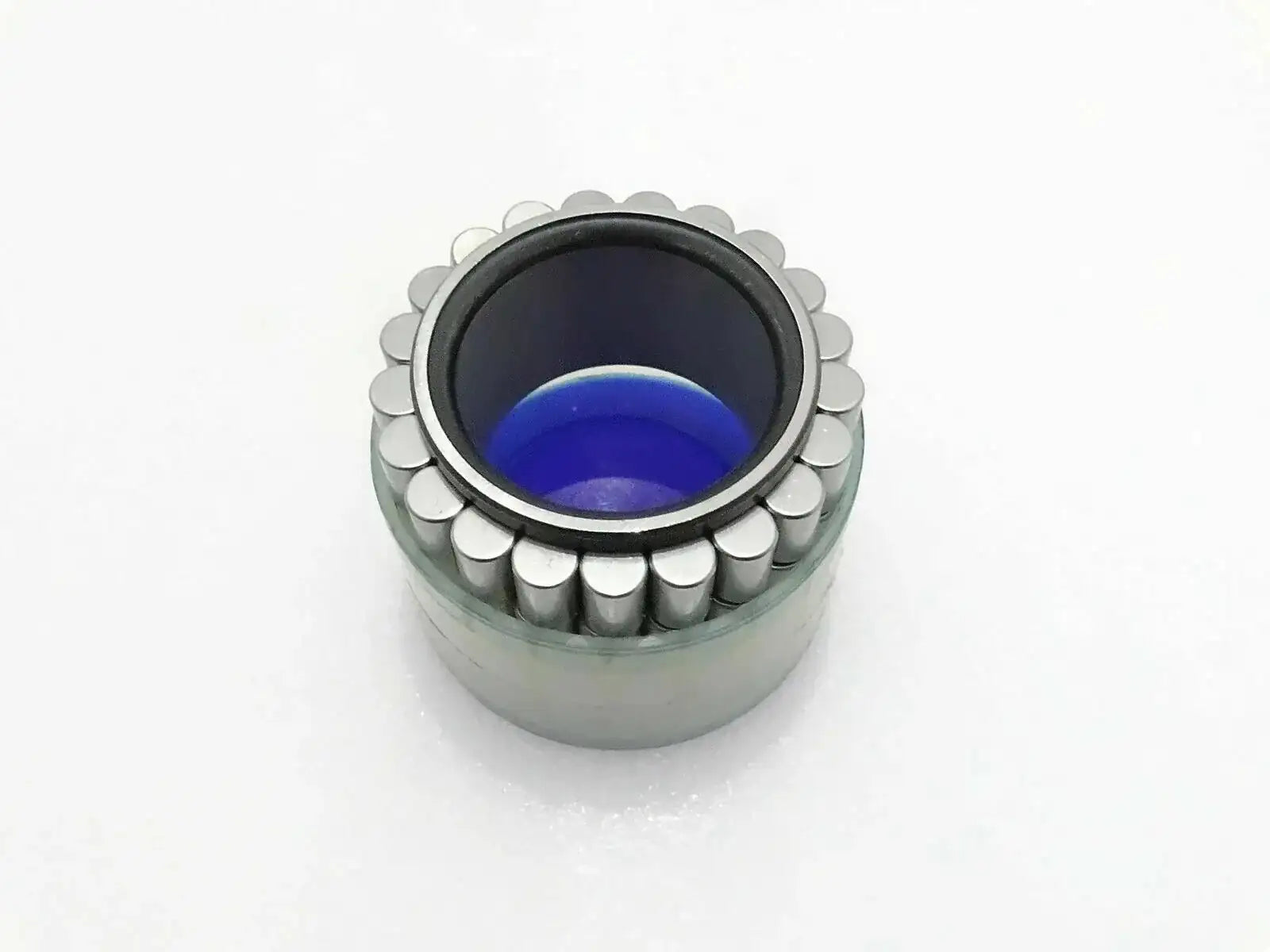 Jcb hub roller bearing with exposed rollers and blue inner grease
