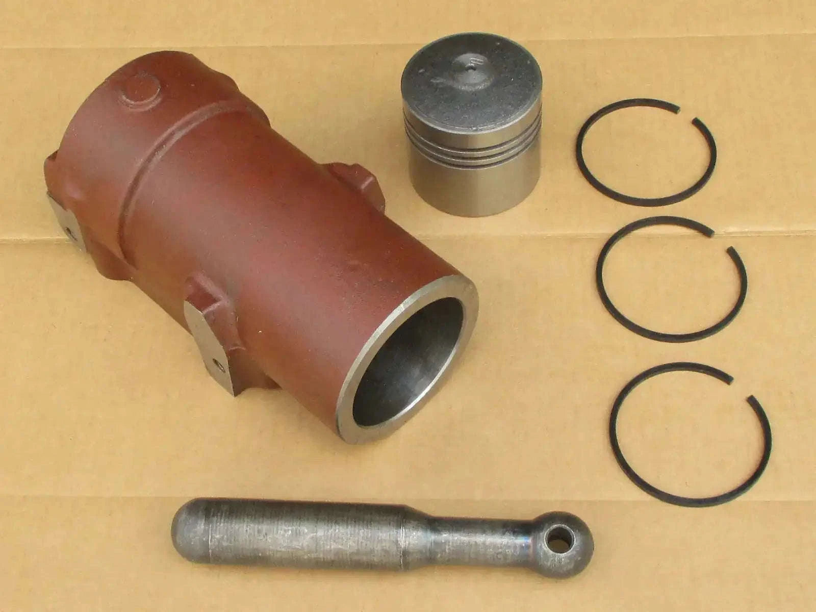 Hydraulic lift pump cylinder assembly with metal sleeve, piston, rod, and three O-ring seals