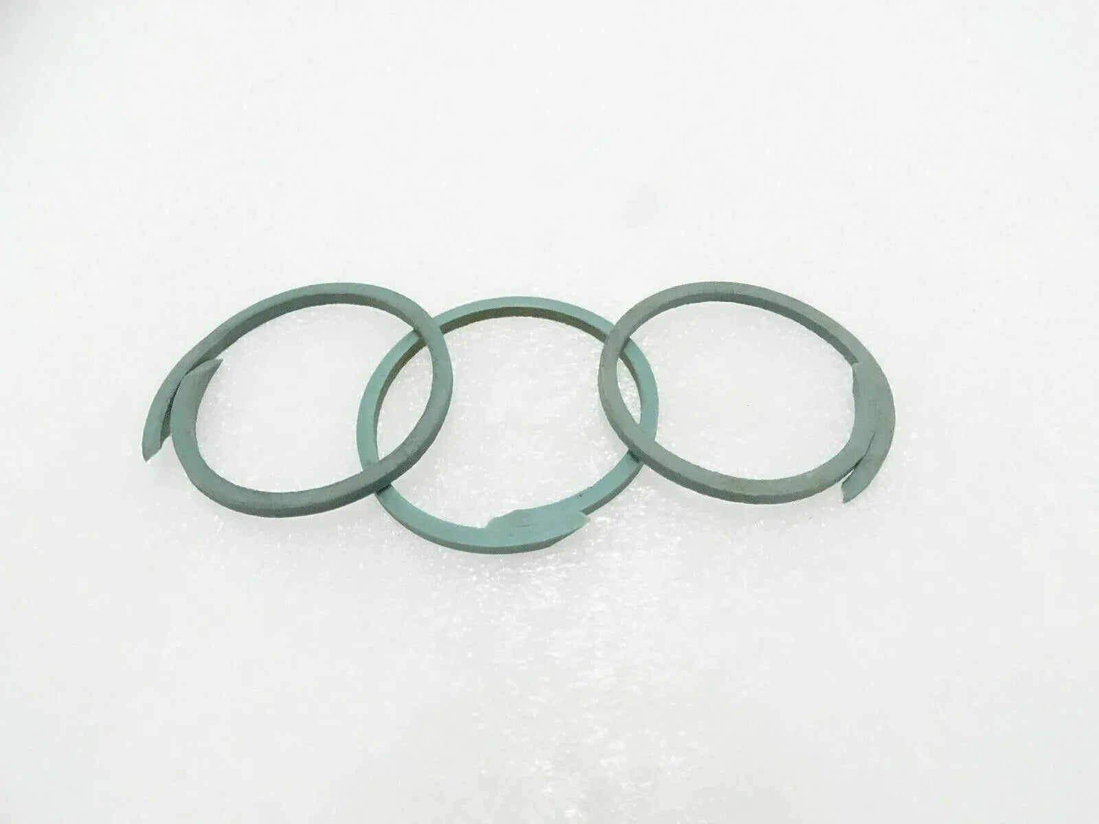 Set of three green seal rings for machinery, circular gasket rings