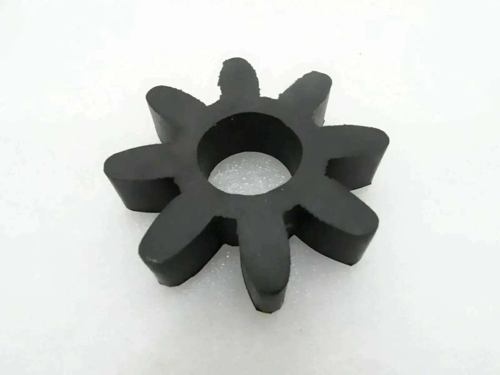 Black rubber coupling disk with star shape and central mounting hole