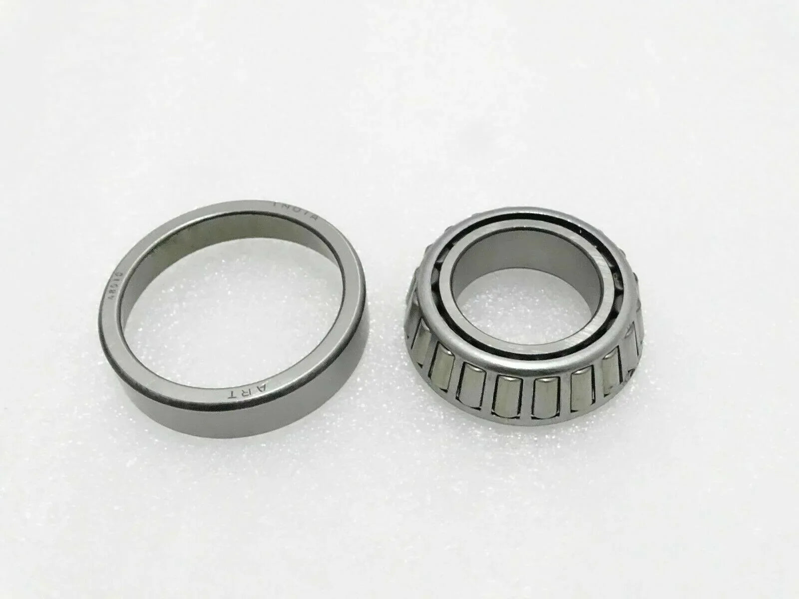 Tapered roller bearing set with inner and outer rings, silver and dark steel