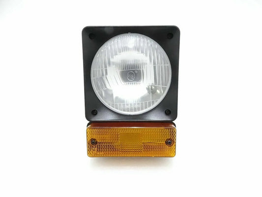Front headlight and amber indicator light unit with round clear lens and black housing