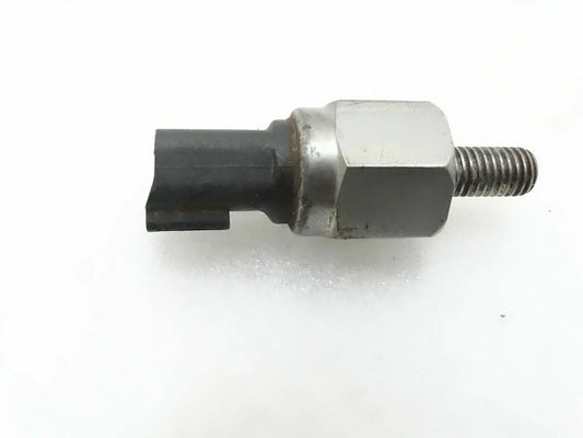 Oil pressure switch with hex metal body, black connector, and threaded stud