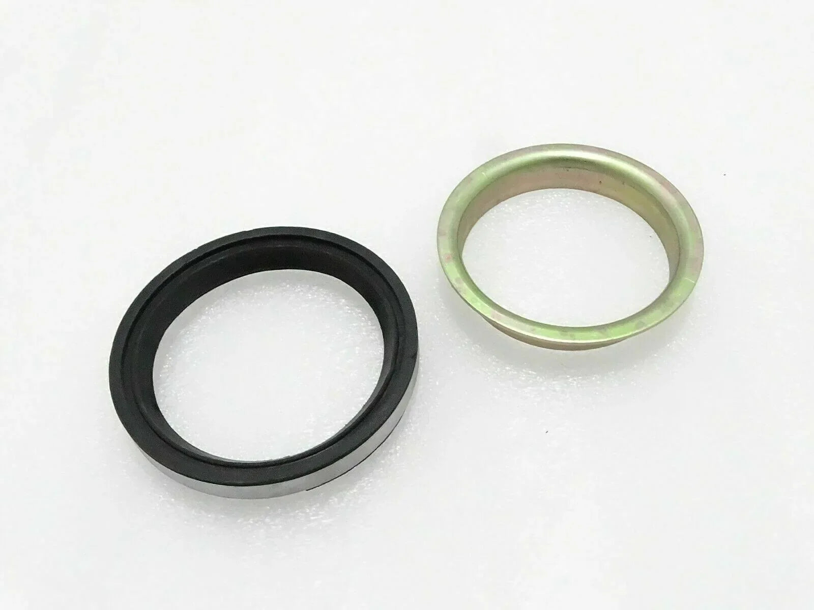 Oil seal and hub sleeve set with black rubber ring and metal outer sleeve