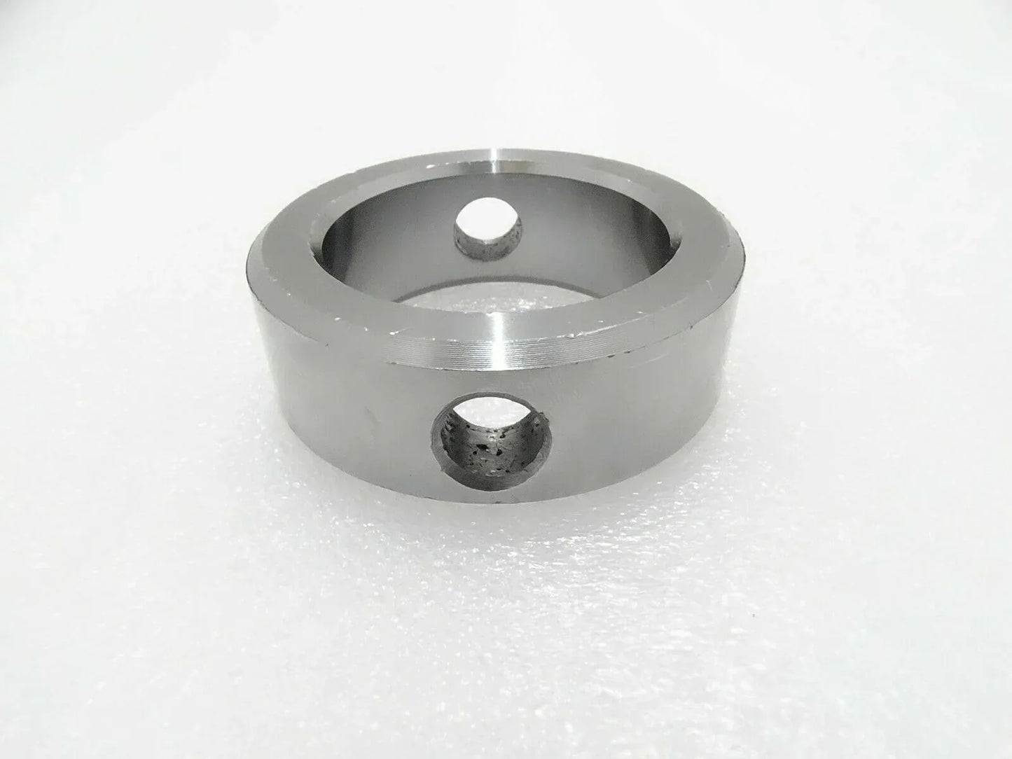 Metal pivot pin boss with two mounting holes, circular housing