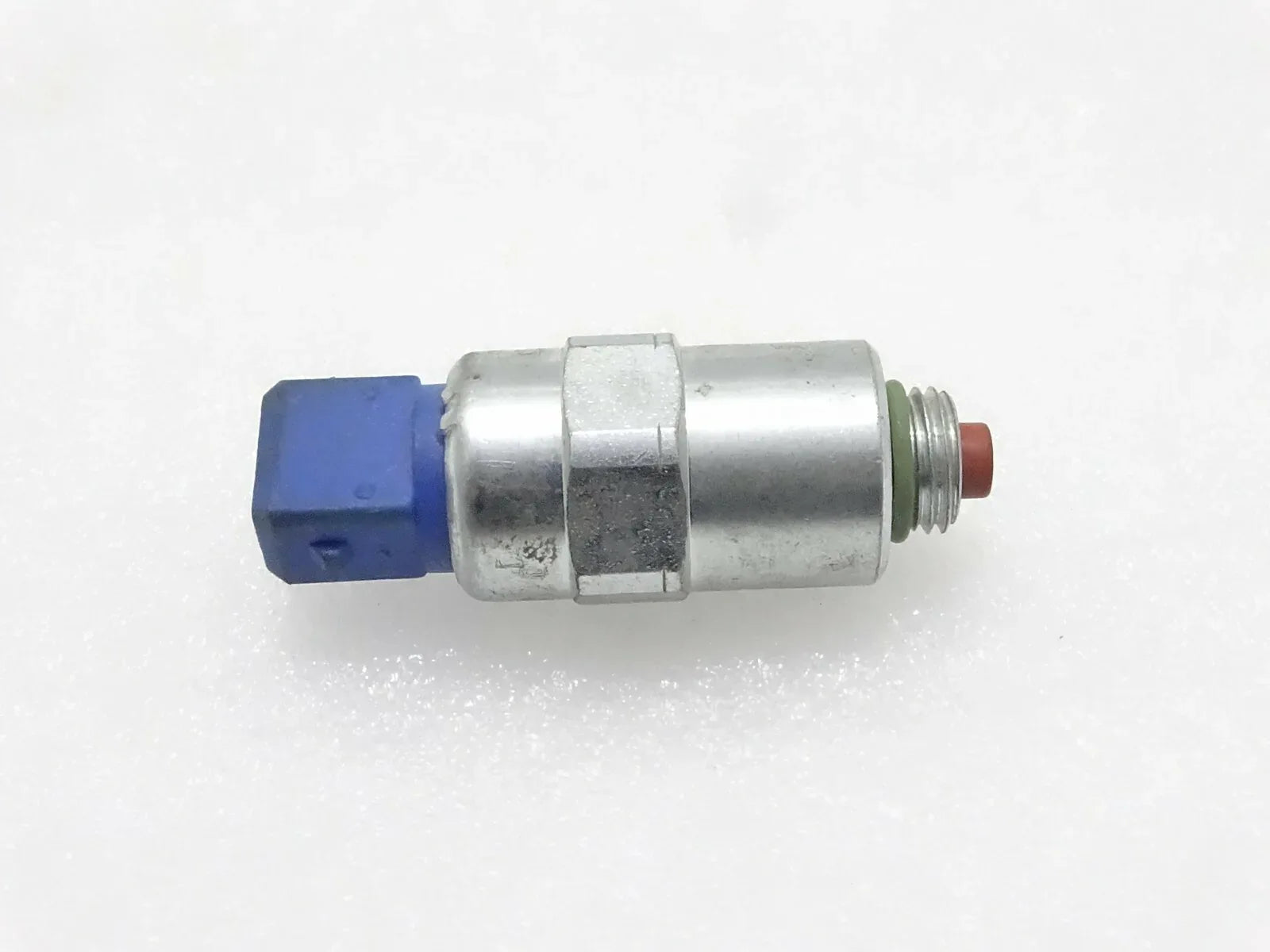 Solenoid fuel pump with metal body, blue connector, and red terminal tip