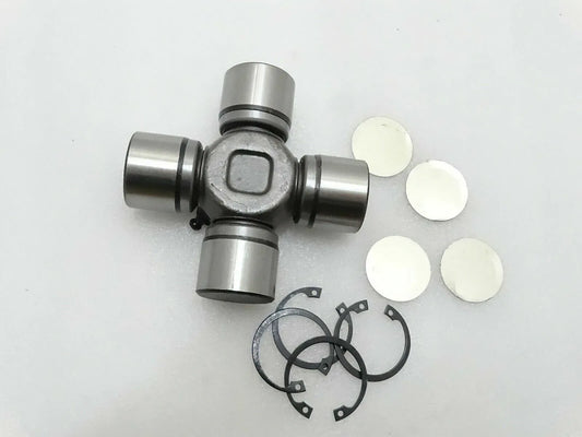 Universal joint with metal yokes, retaining rings, and white spacer washers