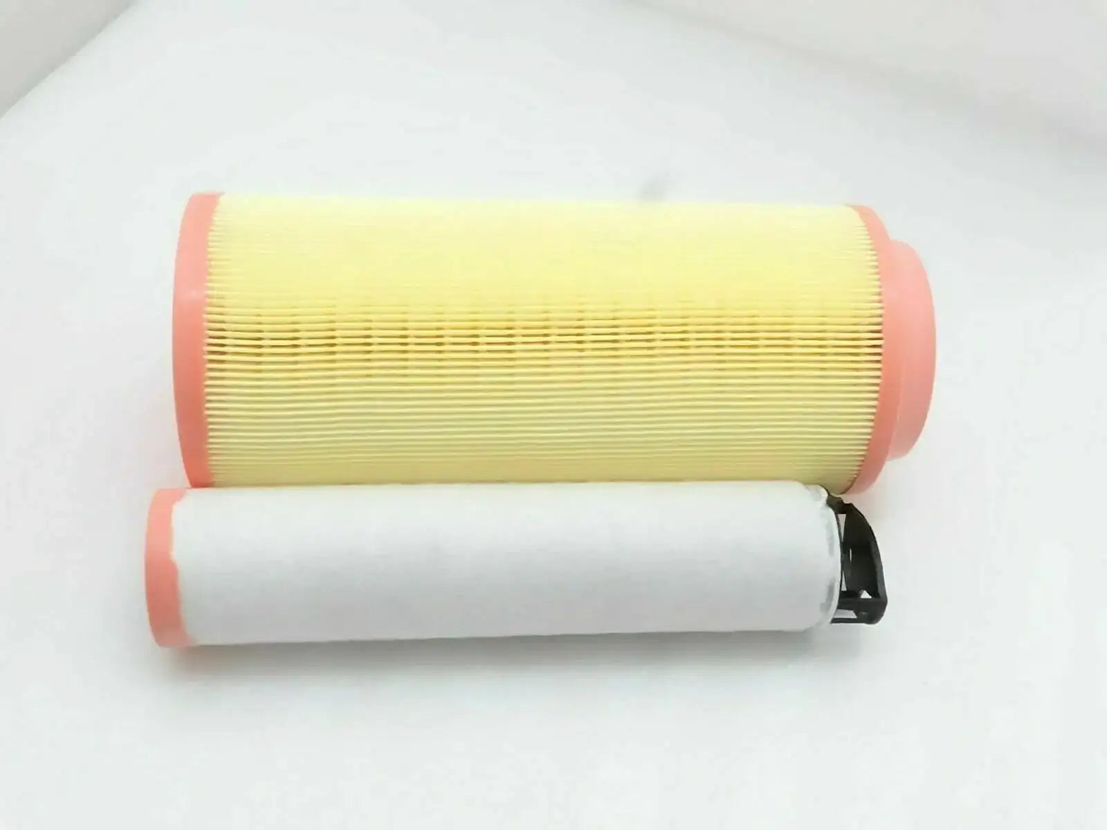 Air filter element with pleated yellow filter media and red end caps