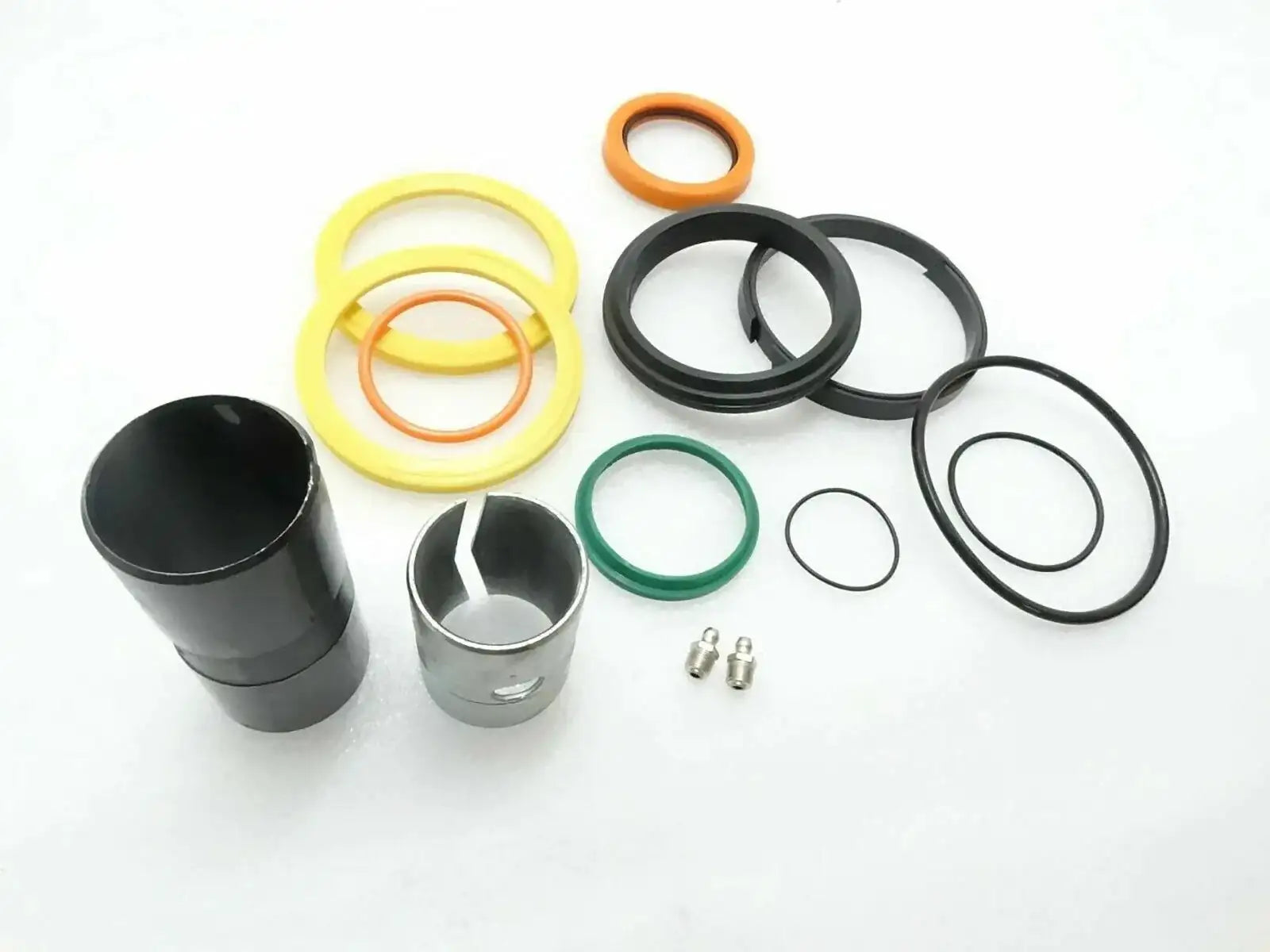 Hydraulic ram repair seal kit with black, yellow and green O-rings and metal bushings