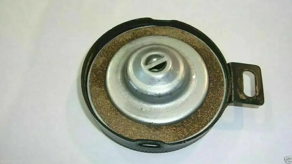 Diesel fuel cap with metal lid, rubber gasket, and mounting bracket