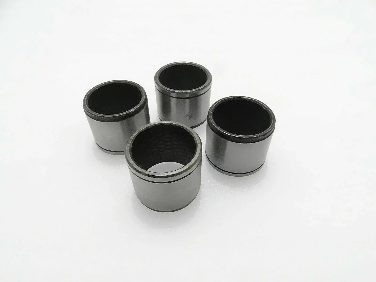 Set of 4 metal link bushings, cylindrical sleeves with open ends