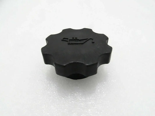 Black engine oil filler cap with ridged circular top and embossed pull tab