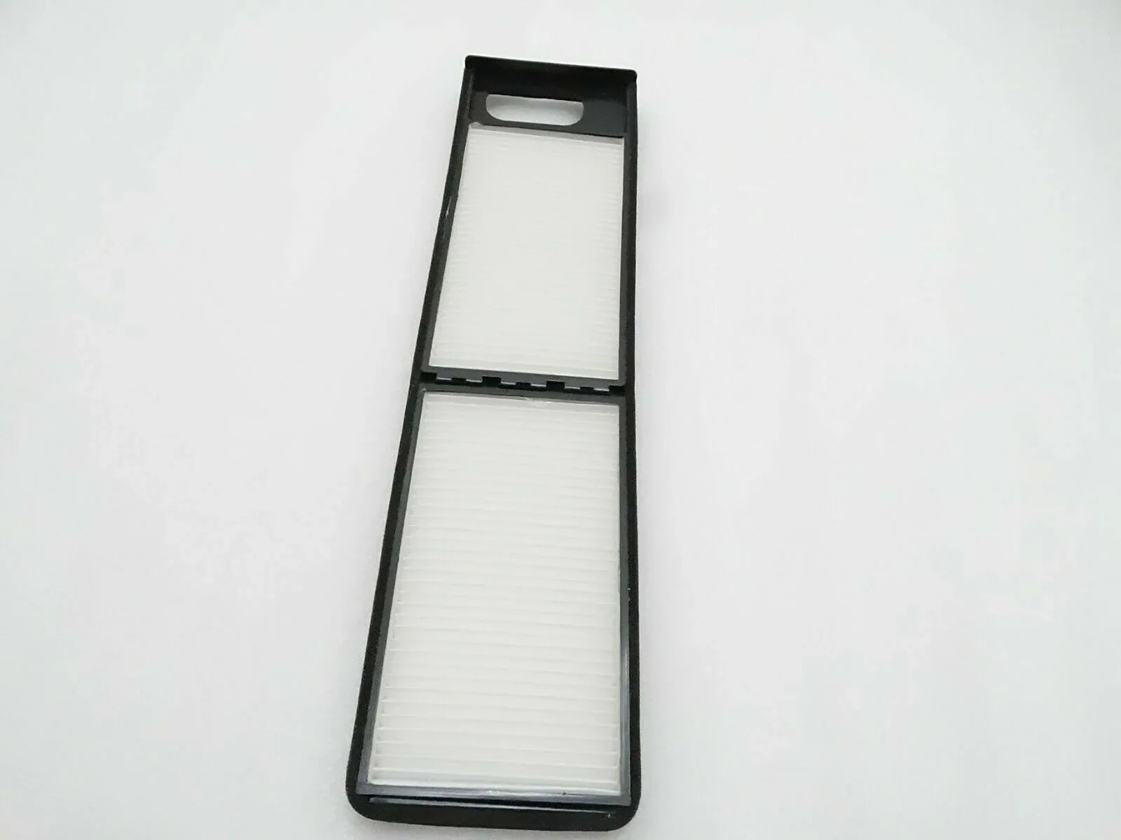 Cab air filter with two rectangular white filter elements in black frame