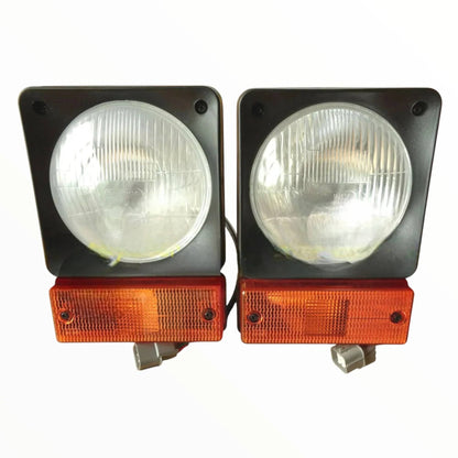 JCB headlamp assembly set featuring dual round headlights with orange side indicators