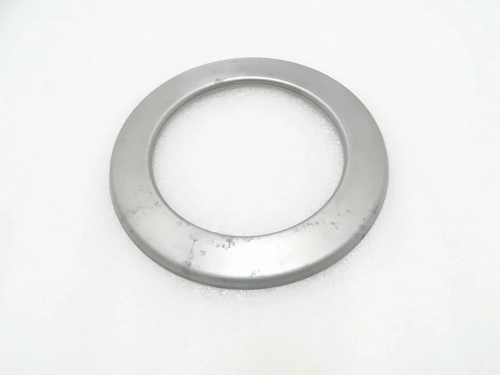 Circular metal hub seal cover with central opening, round flange