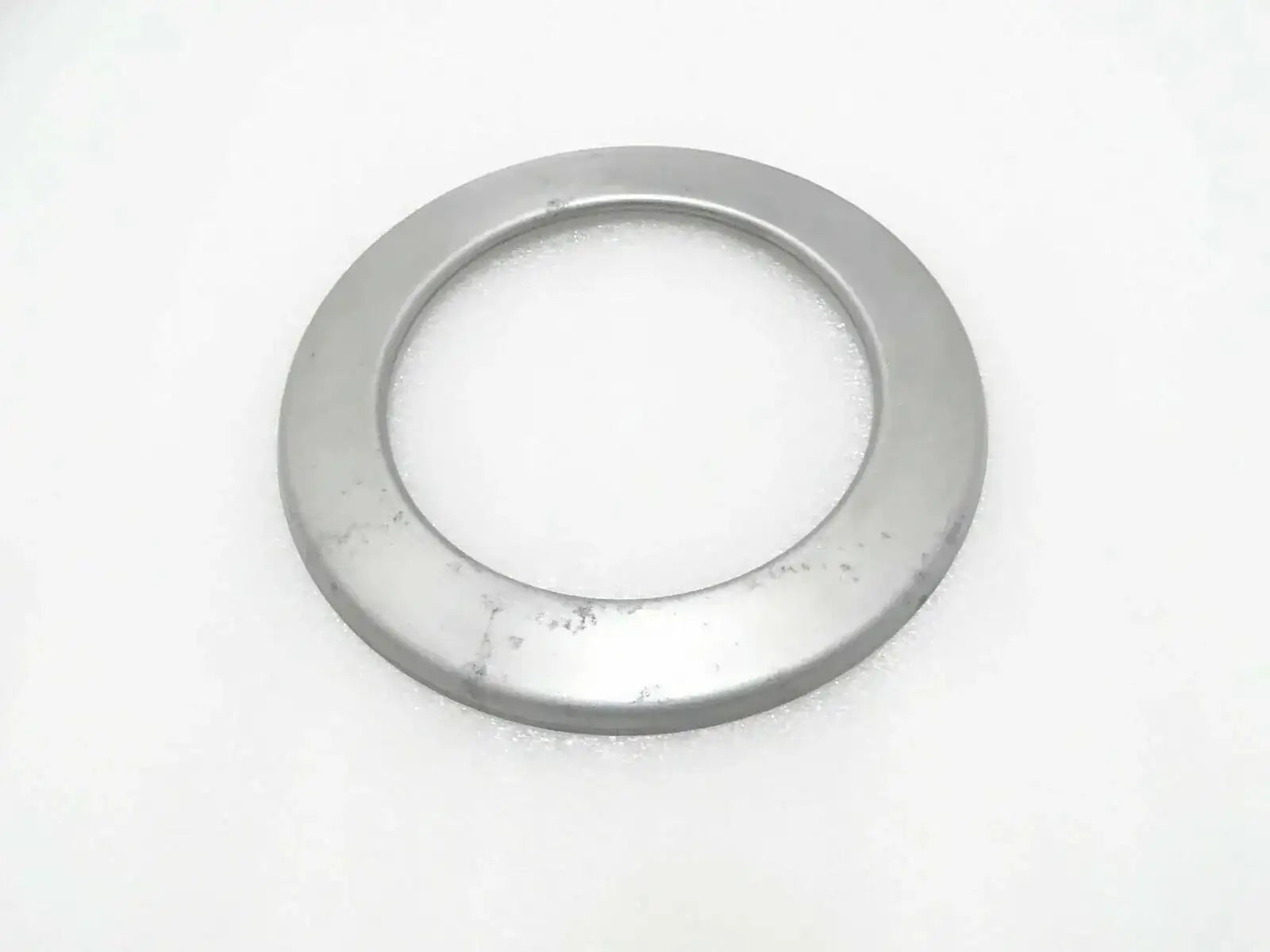 Circular metal hub seal cover with central opening, round flange