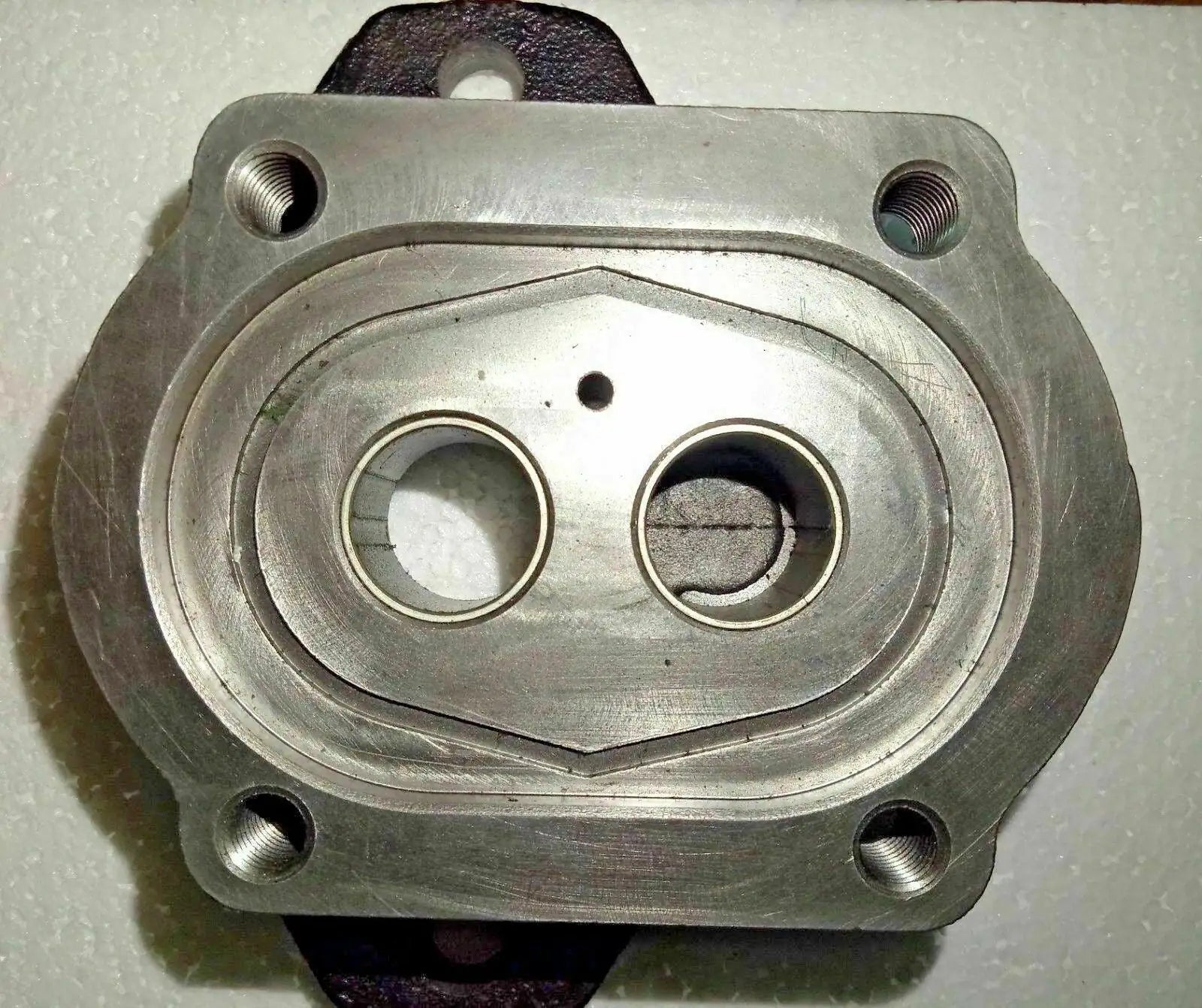 Hydraulic pump mounting flange with two threaded bolt holes and two port openings