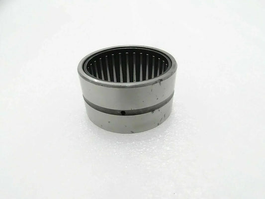 Needle bearing bushing with cylindrical metal housing and inner roller cage